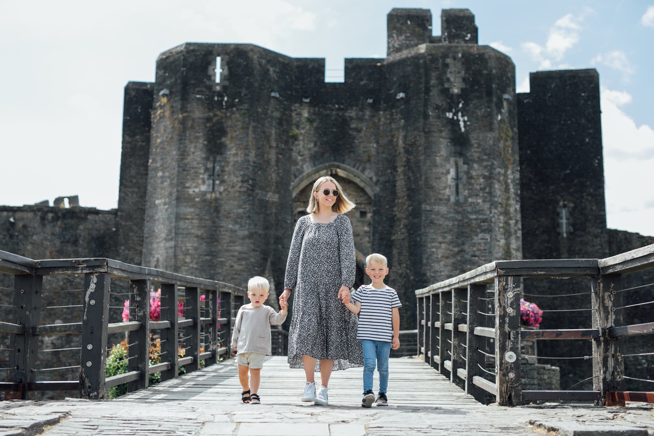 Mother and children walking on a bridge near Caerphilly Castle