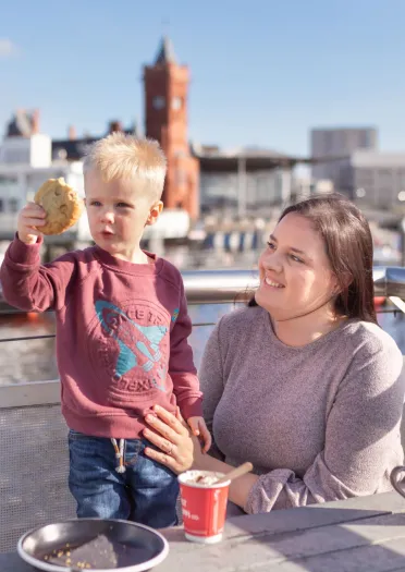 A mother and child enjoying a cuppa and ice cream at Coffi Co, Cardiff Bay.