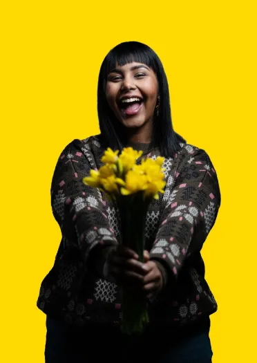 Girl smiling with a bunch of Daffodils