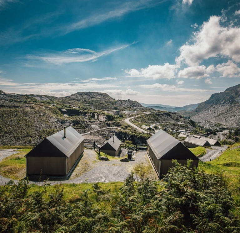 Three glamping huts looking out across Llechwedd slate mountains