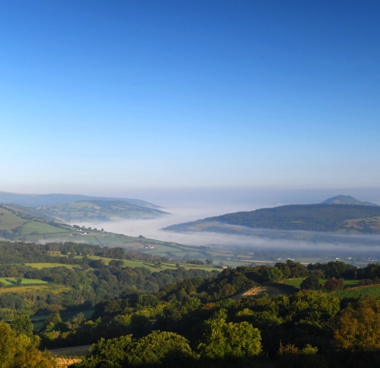 Views over Bannau Brycheiniog from Llangyndir, with mist deep in the valley