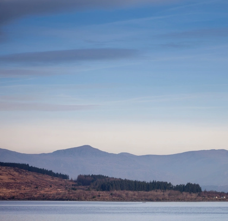 Hazy view of Llyn Trawsfynydd with Eryri mountains in the background 