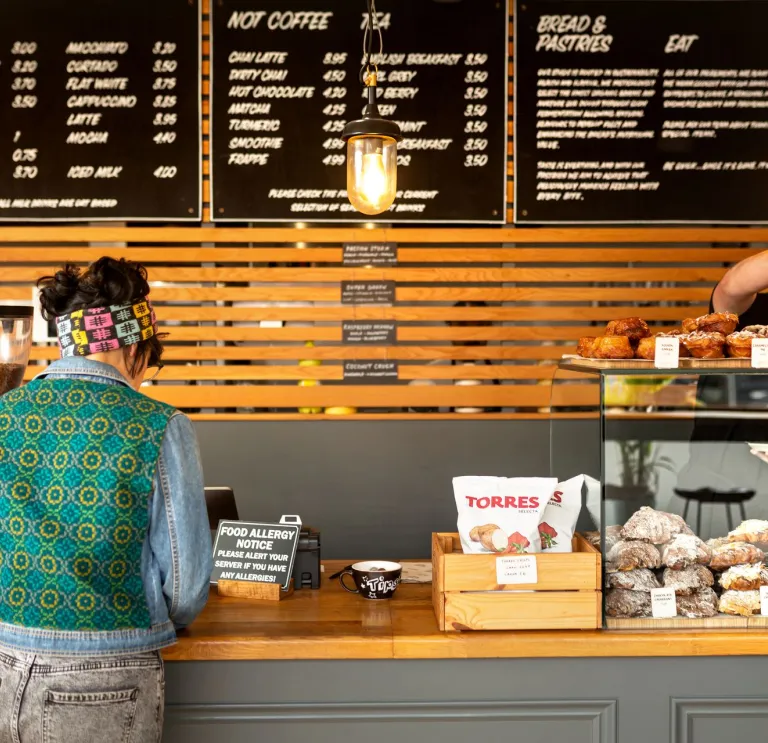 A woman being served at the Alex Gooch Bakery, Whitchurch Road, Cardiff.