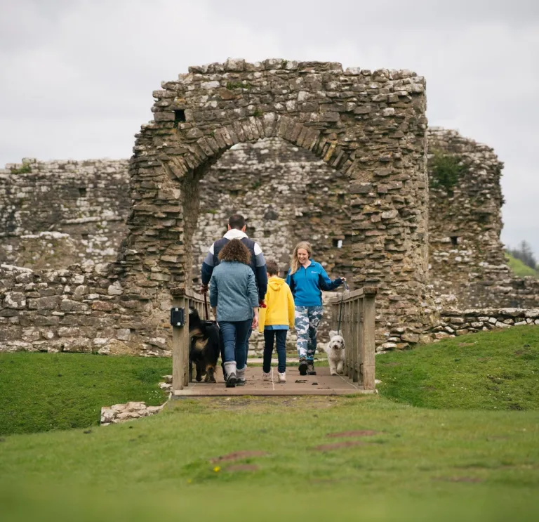 A family and their dog at Ogmore Castle.