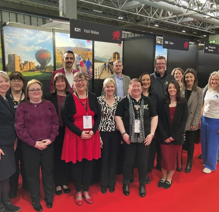 Group of exhibitors attending tourism event