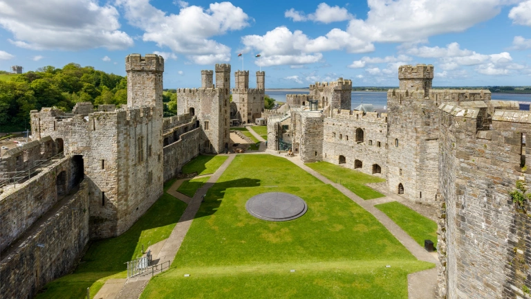 Inside the grounds of a castle with views of the sea beyond.