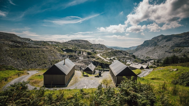 Three glamping huts looking out across Llechwedd slate mountains