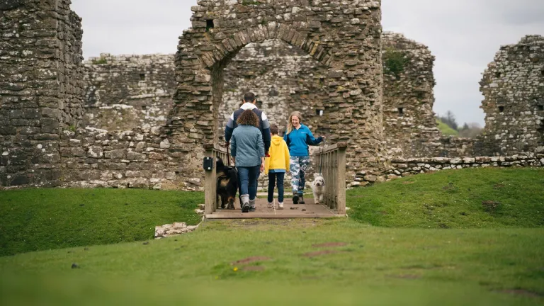 A family and their dog at Ogmore Castle.
