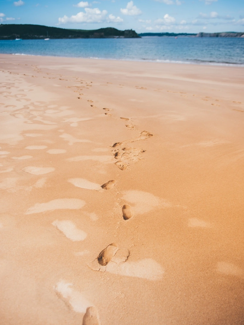 Footprints in the sand at Caldey Island Tenby Pembrokeshire