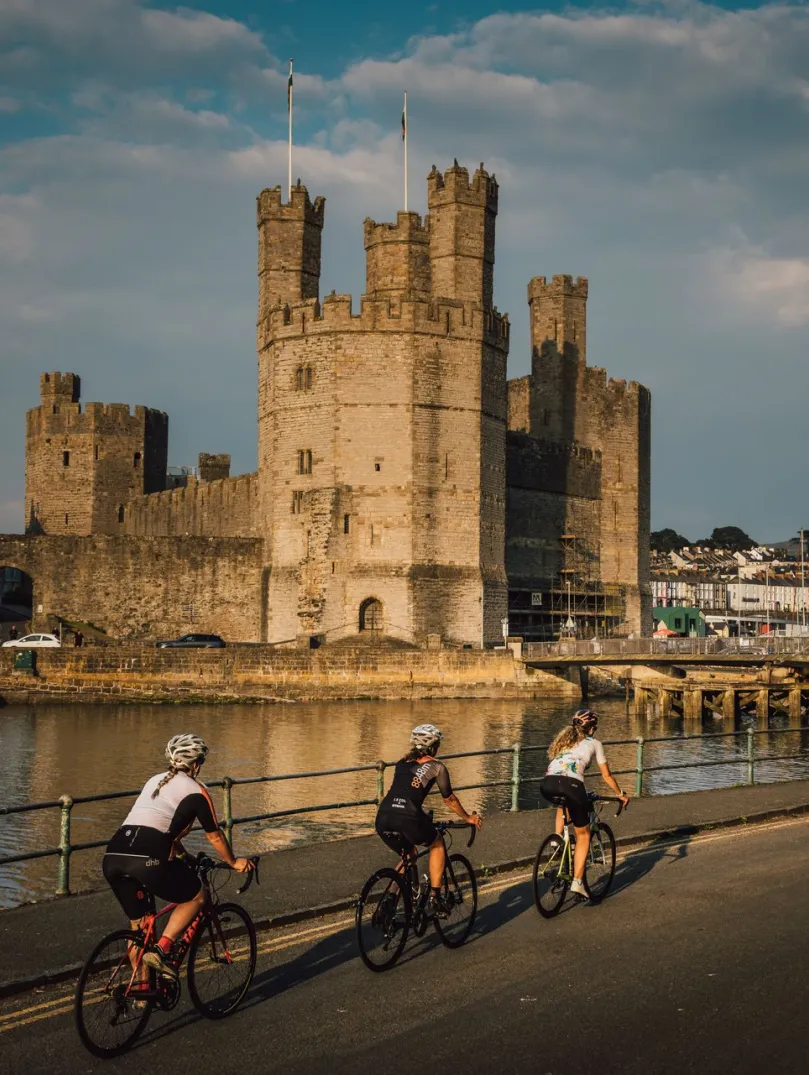 Three cyclists at Caernarfon on the Brailsford Way, North Wales