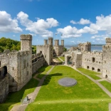 Inside the grounds of a castle with views of the sea beyond.