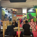 A group of people having a meeting at an exhibition.