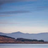 Hazy view of Llyn Trawsfynydd with Eryri mountains in the background 