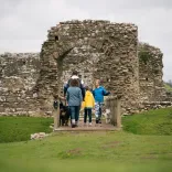 A family and their dog at Ogmore Castle.