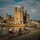 Three cyclists at Caernarfon on the Brailsford Way, North Wales